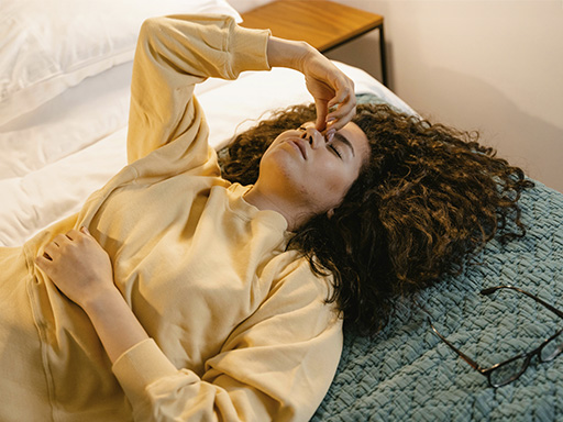 Woman feeling the weight of anxiety symptoms before seeking anxiety treatment.