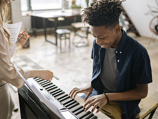 Teenager in a piano class, representing how a neurodiversity-affirming therapy approach helps people with ADHD achieve meaningful growth.