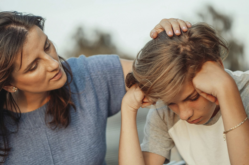Mother comforting her teenage son, representing how parents can best support teens emotions.