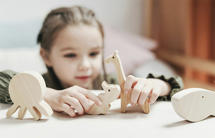 Girl playing with toys, represents the journey  of how our therapist Claire Manley became a counselor.