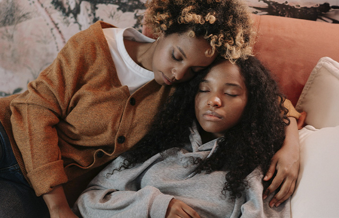 Mother hugging her teen daughter, represents how parents can recognize the signs of depression and support their teens.