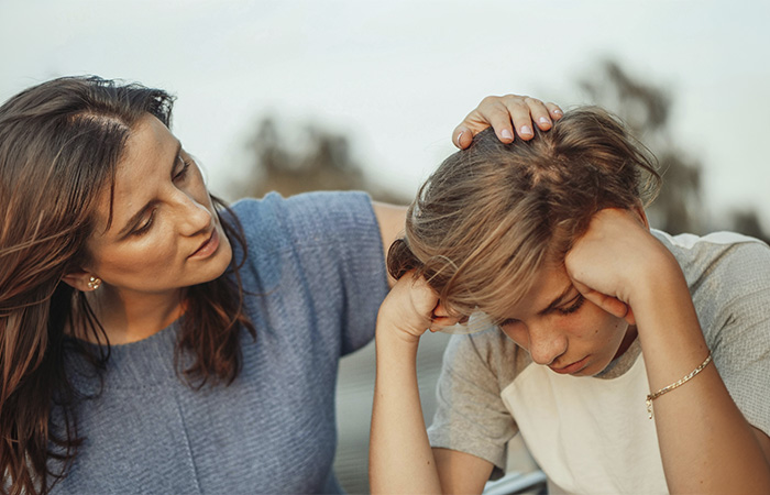 Mother comforting her teen son, represents the story of how our therapist became a counselor.