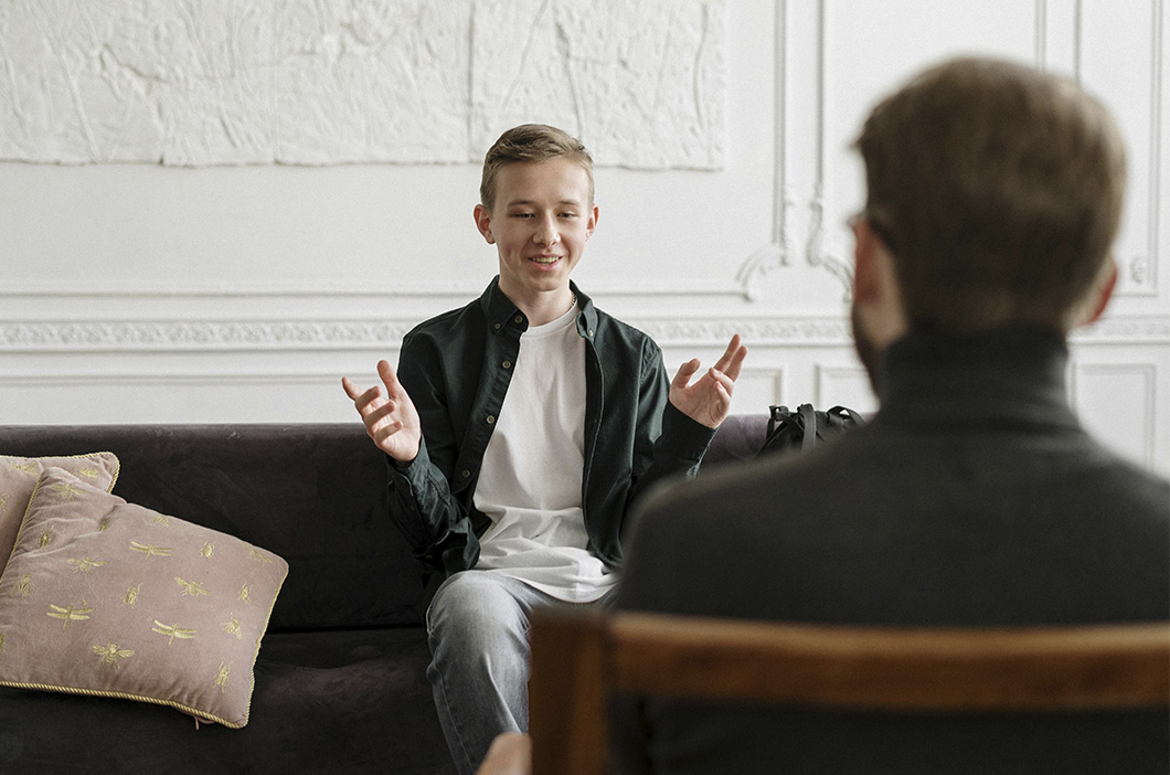 Teen on a couch talking with his therapist during a counseling session, represents Bradley C. McGinnis journey to became a therapist.