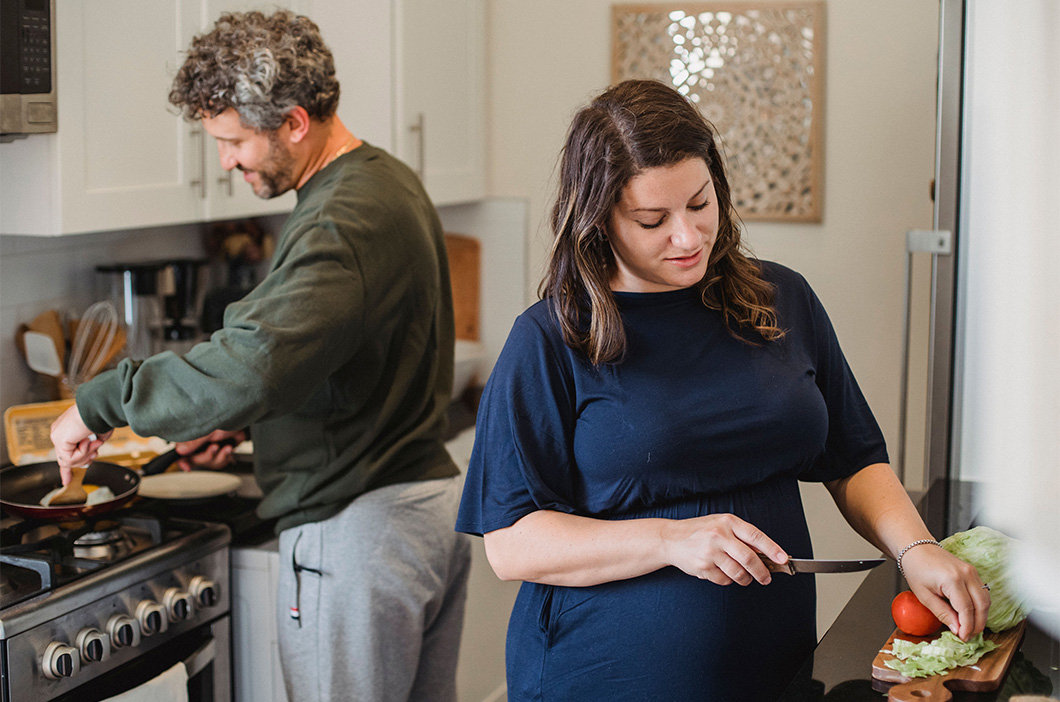 Couple in the kitchen cooking, represents how intensive marriage Gottman therapy can help busy couples reconnect and overcome their issues.